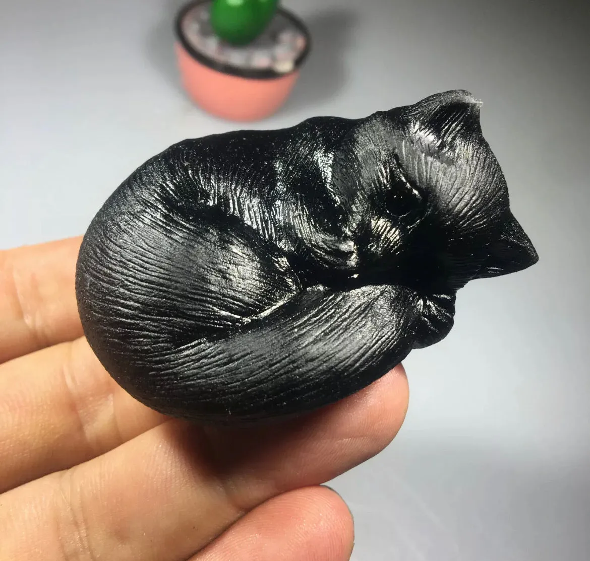 Black obsidian gemstone carved sleeping kitty cat