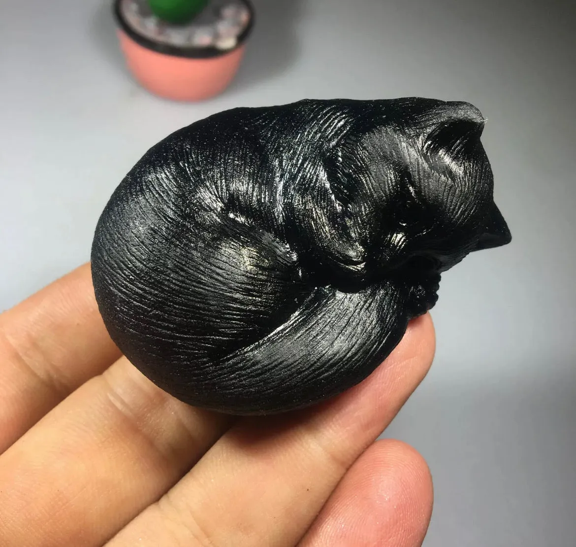 Black obsidian gemstone carved sleeping kitty cat