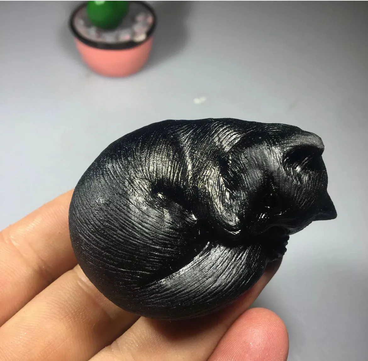 Black obsidian gemstone carved sleeping kitty cat