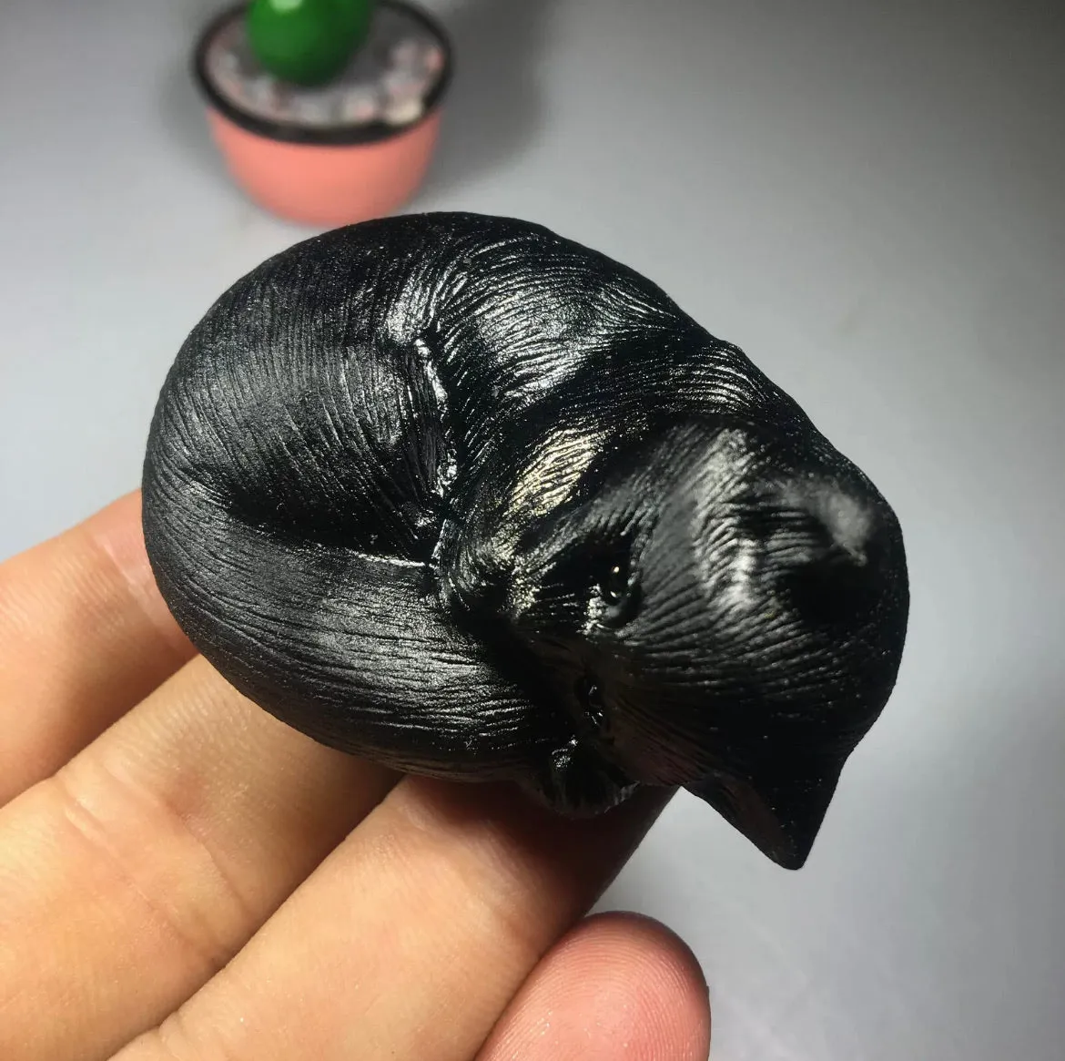 Black obsidian gemstone carved sleeping kitty cat